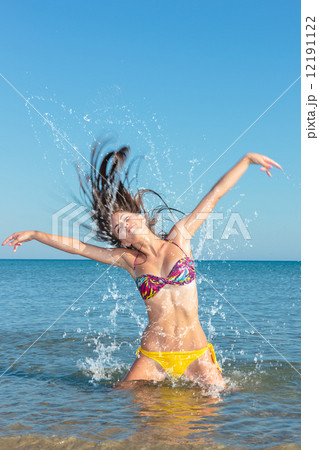 Beauty Model Girl Splashing Water in the ocean 12191122