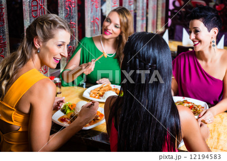 Young people eating in Asia restaurant Young people eating in Asia restaurant 12194583