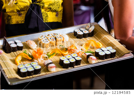 Waitress with sushi in asian restaurant Waitress with sushi in asian restaurant 12194585