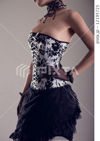 Sensual young woman in black and white corset with floral patter 12195725