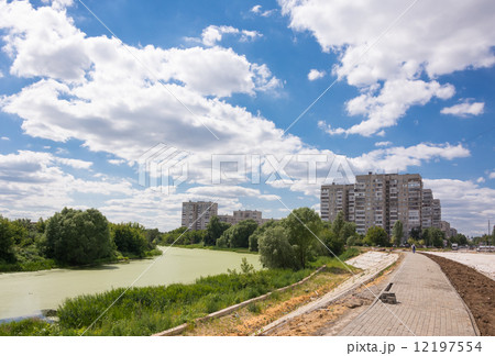 Suburban landscape with clouds, vegetation, and the image of apartment buildings 12197554