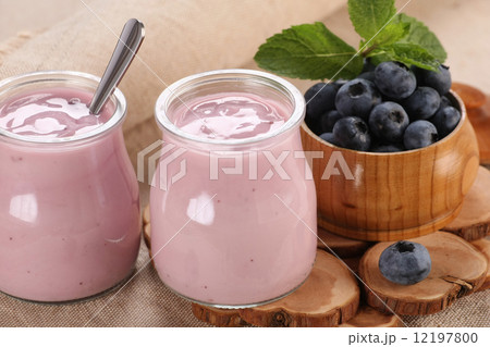 yogurt with blueberries in a glass jar and blueberries in a glas 12197800