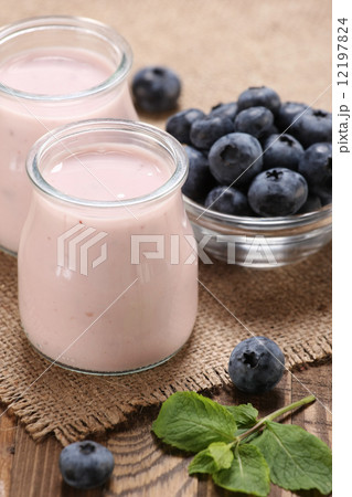 yogurt with blueberries in a glass jar and blueberries in a glas 12197824