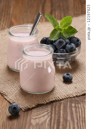 yogurt with blueberries in a glass jar and blueberries in a glas 12197825