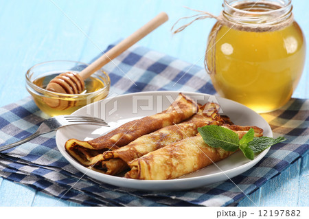 pancakes with honey on a plate, the honey in a glass bowl pancakes with honey on a plate, the honey in a glass bowl 12197882