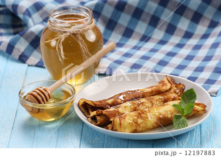 pancakes with honey on a plate, the honey in a glass bowl pancakes with honey on a plate, the honey in a glass bowl 12197883