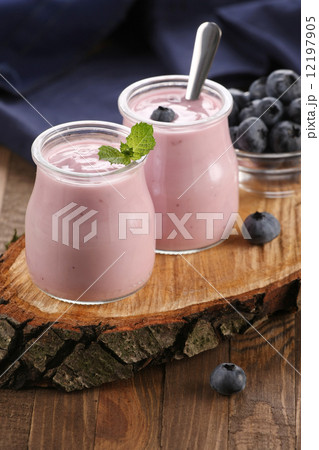 yogurt with blueberries in a glass jar and blueberries in a glas yogurt with blueberries in a glass jar and blueberries in a glas 12197905