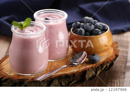 yogurt with blueberries in a glass jar and blueberries in a wood yogurt with blueberries in a glass jar and blueberries in a wood 12197906