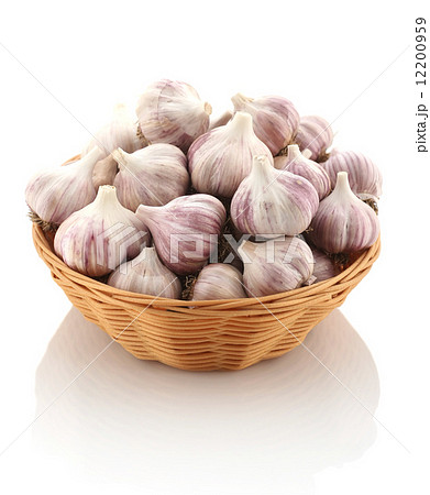 garlic in a wicker basket on a white background garlic in a wicker basket on a white background 12200959