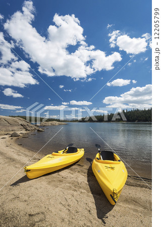 Pair of Yellow Kayaks on Beautiful Mountain Lake Shore. 12205799