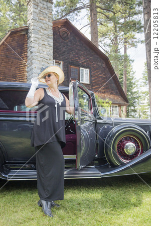 Attractive Woman in Twenties Outfit Near Antique Automobile Attractive Woman in Twenties Outfit Near Antique Automobile 12205813