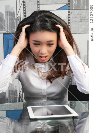 Asian female employee stressed with work Asian female employee stressed with work 12207009