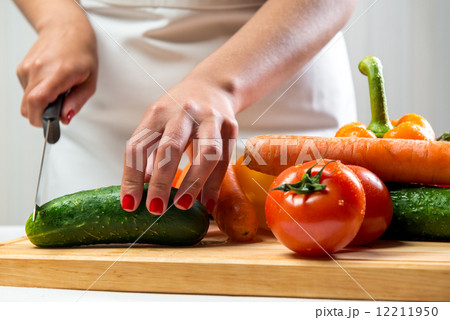 Woman cutting vegetables for a salad 12211950