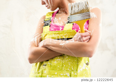 Female in coverall holding paint brush Female in coverall holding paint brush 12222645