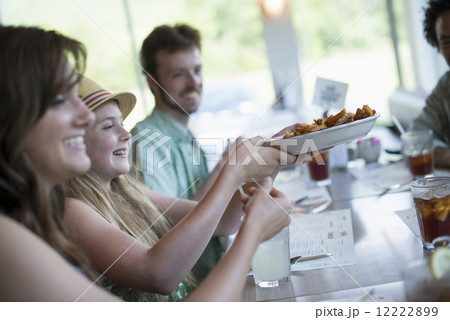 A group of friends eating at a diner. A group of friends eating at a diner. 12222899