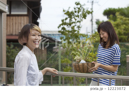 Two women standing in a garden. 12223072
