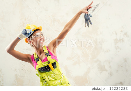 Female construction worker posing over white obsolete background 12223288