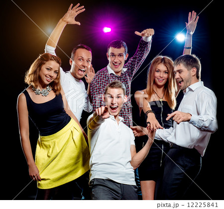 Cheerful group of young people dancing at party Cheerful group of young people dancing at party 12225841