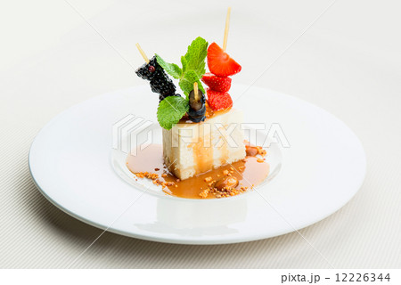 Delicious cheesecake and fresh berries on white plate 12226344