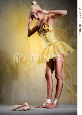 Beautiful ballerina in yellow tutu indoors Beautiful ballerina in yellow tutu indoors 12227211