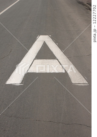 The white sign on the road Bus lane in the form of a big capital letter A The white sign on the road Bus lane in the form of a big capital letter A 12227702