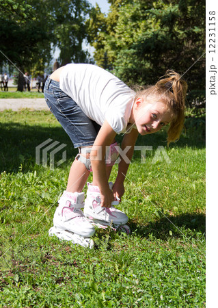 Cute girl on roller skates in summer Cute girl on roller skates in summer 12231158