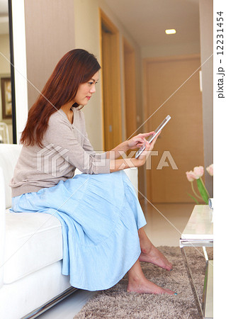 Young Women, Home, Resort, Hotel, apartment, Condo, Lifestyle, playful, tablet, Laptop, siting, sofa Young Women, Home, Resort, Hotel, apartment, Condo, Lifestyle, playful, tablet, Laptop, siting, sofa 12231454