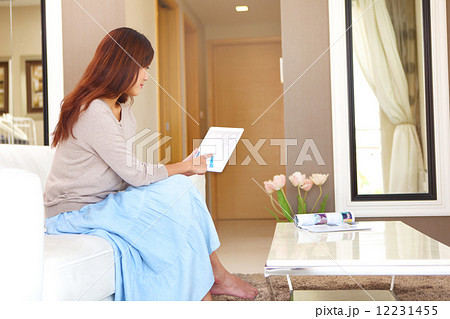 Young Women, Home, Resort, Hotel, apartment, Condo, Lifestyle, playful, tablet, Laptop, siting, sofa Young Women, Home, Resort, Hotel, apartment, Condo, Lifestyle, playful, tablet, Laptop, siting, sofa 12231455