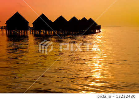 Maldives. .Villa on piles on water at the time sunset.. 12232430