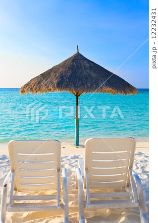 Parasol and chaise lounges, Maldives. 12232431