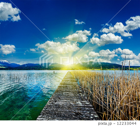 Pier in the lake, countryside on sunset 12233044