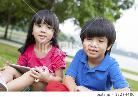 Two kids playing in the park. Two kids playing in the park. 12234486