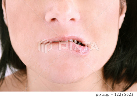 an embarrassed woman biting on her lip 12235623