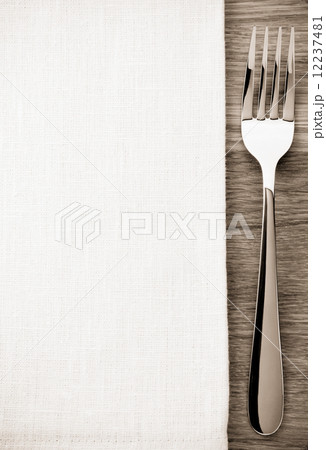 fork and napkin on wood 12237481