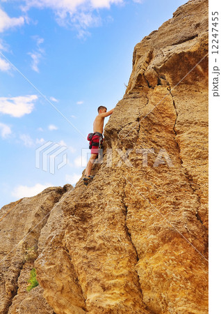 man climbing on rock man climbing on rock 12247455