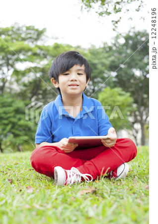 Young boy playing in the park. Young boy playing in the park. 12248196