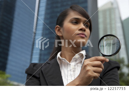 Businesswoman with magnifying glass Businesswoman with magnifying glass 12257755