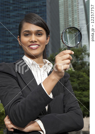 Businesswoman with magnifying glass Businesswoman with magnifying glass 12257757