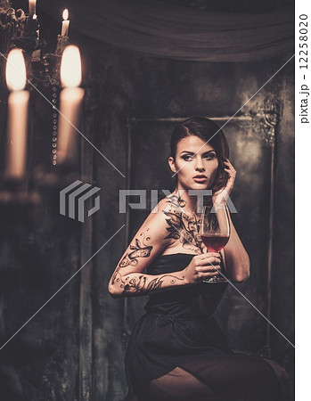 Tattooed beautiful woman in old spooky interior 12258020