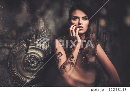 Tattooed beautiful woman in old spooky interior Tattooed beautiful woman in old spooky interior 12258113