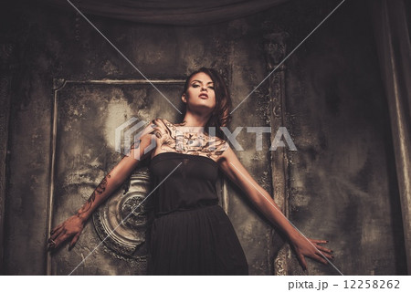 Tattooed beautiful woman in old spooky interior Tattooed beautiful woman in old spooky interior 12258262