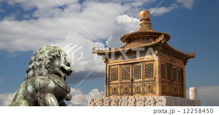 Bronze Guardian Lion Statue and bronze pagoda in the Forbidden City, Beijing, China 12258450