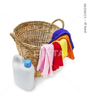Colorful clothes in a laundry wooden basket on white background Colorful clothes in a laundry wooden basket on white background 12260290