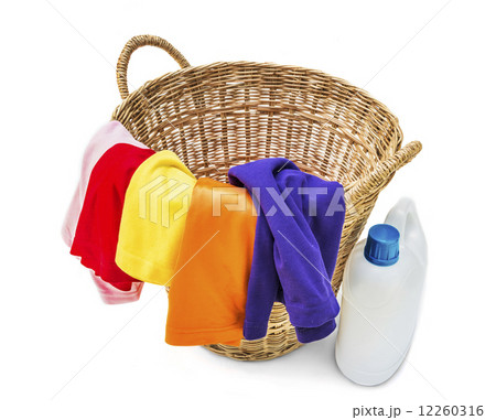 Colorful clothes in a laundry wooden basket on white background 12260316