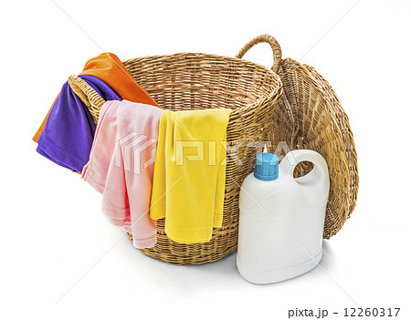 Colorful clothes in a laundry wooden basket on white background 12260317