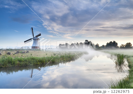 windmill and river in foggy morning windmill and river in foggy morning 12262975
