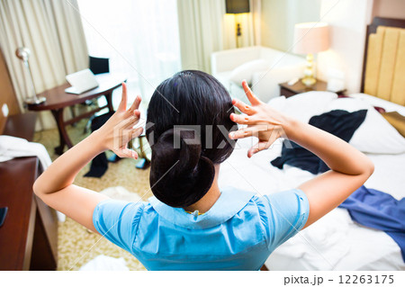 Chambermaid cleaning in Asian hotel room Chambermaid cleaning in Asian hotel room 12263175
