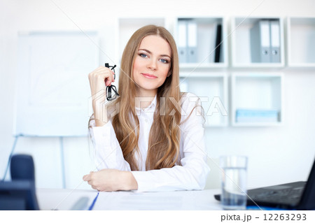 Portrait of beautiful young business woman sitting at desk in br Portrait of beautiful young business woman sitting at desk in br 12263293