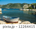 An old fishing boat moored at Simena peninsula with an ancient i 12264415