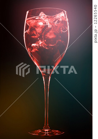 Cocktail with ice cubes on dark background Cocktail with ice cubes on dark background 12265540